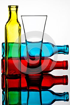 Coloured Bottles and Glass Reflected in a Mirror