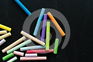 Coloured chalks on a black background. Back to class. Copy space