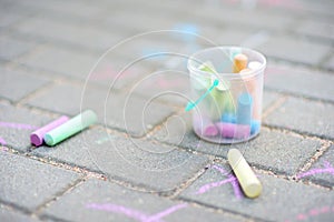 Coloured chalks on a sidewalk