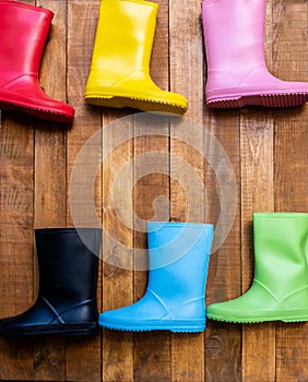 Coloured Children's Wellington Boots Pinned To A Wooden Fence