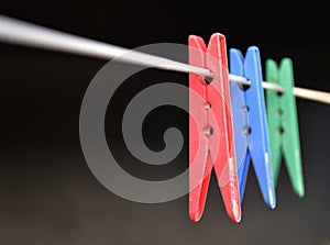 Coloured clothes pegs on washing line