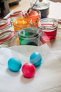 Coloured colored Easter eggs dry on paper towel after cold Easter color dye in red, orange, yellow, green, blue in domestic