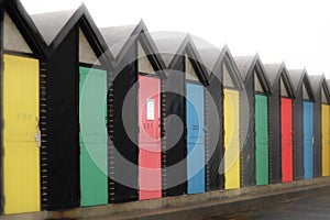 Coloured doors on beach huts in a row