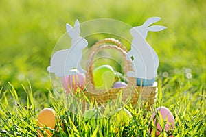 Coloured Easter Eggs In Basket Padded Out With Rabbit Decorations