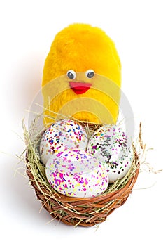 Coloured eggs, base and yellow chicken - the symbol of Easter