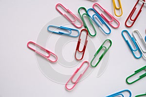 Coloured paper clips on a white background