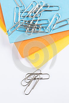 Coloured paper with paperclips on top
