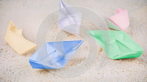 Coloured Paper Ships Chaotic Laying on Sandy in the Desert