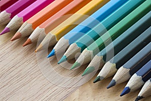 Coloured pencils against a wooden background