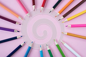 Coloured pencils isolated on pink background