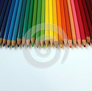 Coloured Pencils in a Row on a White Background