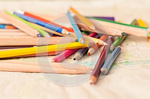 Coloured pencils scattered on table. crayons