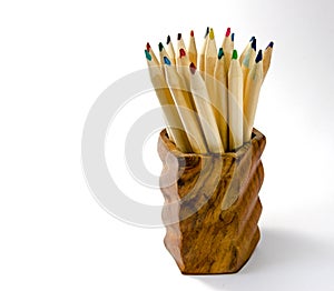 Coloured pencils in wooden cup