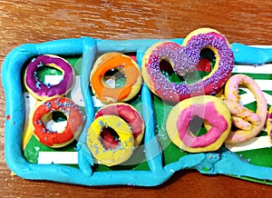 Coloured plasticine doughnuts and pretzels