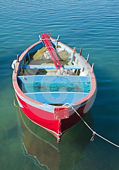 Coloured rowboat in clear sea.