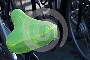 A coloured saddle cover on a parked bike