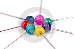 coloured sewing pins on a white background