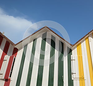 Coloured striped beach huts in the summers sun