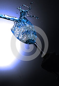 Coloured water being poured into a Wine Glass.