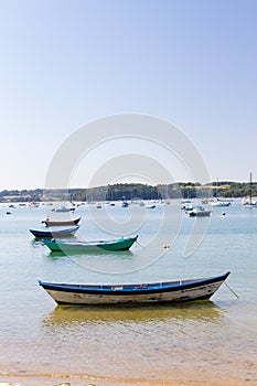 Coloured wooden fishing boats moored in calm bay