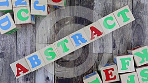 Colourful alphabet letters on wooden cubes with word - abstract. Stop motion