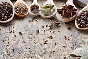 Colourful aromatic various spices for cooking on old wooden barrel, close-up, flat lay, selective focus, copy space.