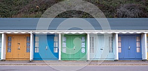 Colourful beach huts located on the promenade on the Bournemouth UK sea front.