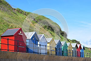 Colourful beach sheds.