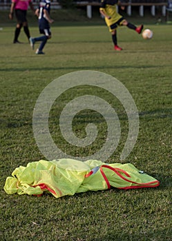 Colourful bibs left on a football pitch, ready for the next training session to come.