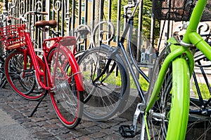 Colourful bicycles parked by railings in Copenhagen