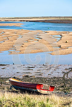 Colourful boats marooned on sandbanks