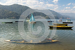 Colourful boats scattered on the Phewa Tal Lake in Pokhara, Nepal