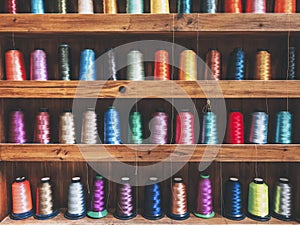 Colourful Bobbins on shelf Thread Textile Fabric Industrial