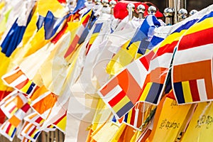 Colourful buddhist prayer flags draped at the entrance to a temp