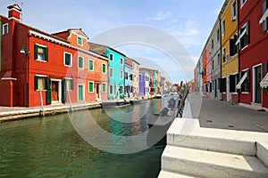 Colourful buildings lining cannal, Island of Burano, Venice Italy