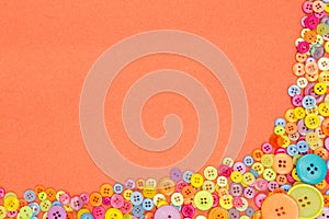 Colourful buttons on an orange background with copy space.