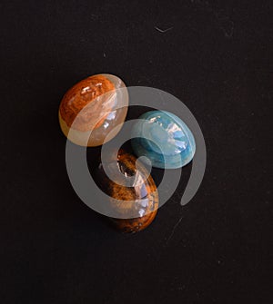 A Colourful Composition of three Gemstones, Brown, Orange, Pink and Turkish Blue on Black