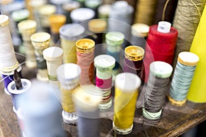 Colourful cotton bobbins and thread in a tailors shop