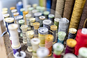 Colourful cotton bobbins and thread in a traditional tailors shop