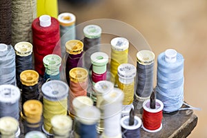 Colourful cotton bobbins and thread in a traditional tailors shop