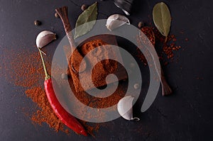 Colourful different spices on black stone plate. Spicy cooking