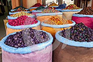 A colourful display of sacks containing various grains, herbs and spices for sale in the Marrakesh medina, Morocco.