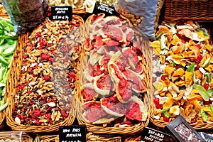 Colourful display of various candied fruits, and mixed nuts for sale at La Boqueria market in Barcelona