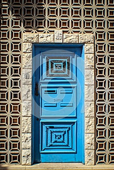 Colourful door surrounded by geometric stones