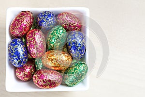 Colourful easter eggs in white bowl