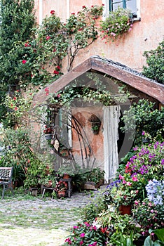 Colourful entrance of a countryhouse, decoration of many flowers