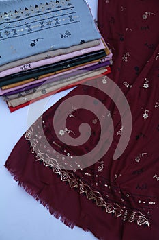 Colourful fabrics, cloth, hijabs or scarves with prints and designs. Textile industry product photography