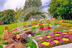 Colourful Flowerbeds and a wheelbarrow off to the side in an Attractive Ukrainian Formal Garden.