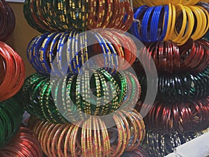 Colourful glass bangles close up. Bangles neatly stacked  in a shop