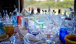 Colourful glass collectables in charity shop window interior viewed from inside, charity chic for recycle, reuse and re purpose